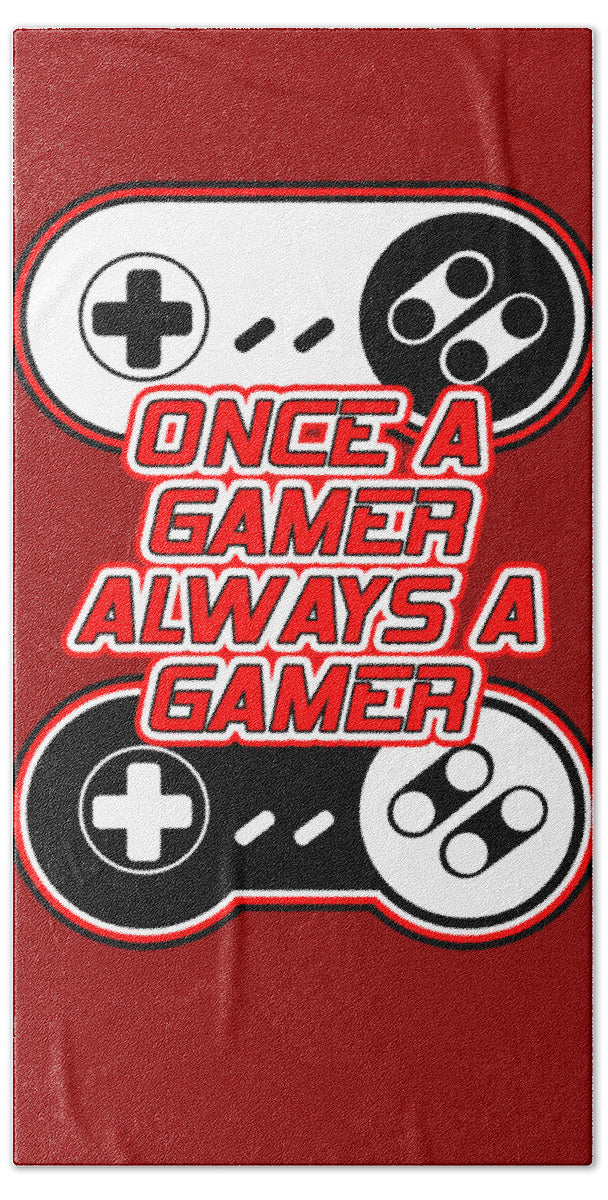 Red beach towel with game controller and joystick icons and 'ONCE A GAMER ALWAYS A GAMER' text
