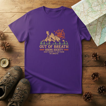Purple hiking graphic T-shirt with mountain cabin and compass emblem, crew neck