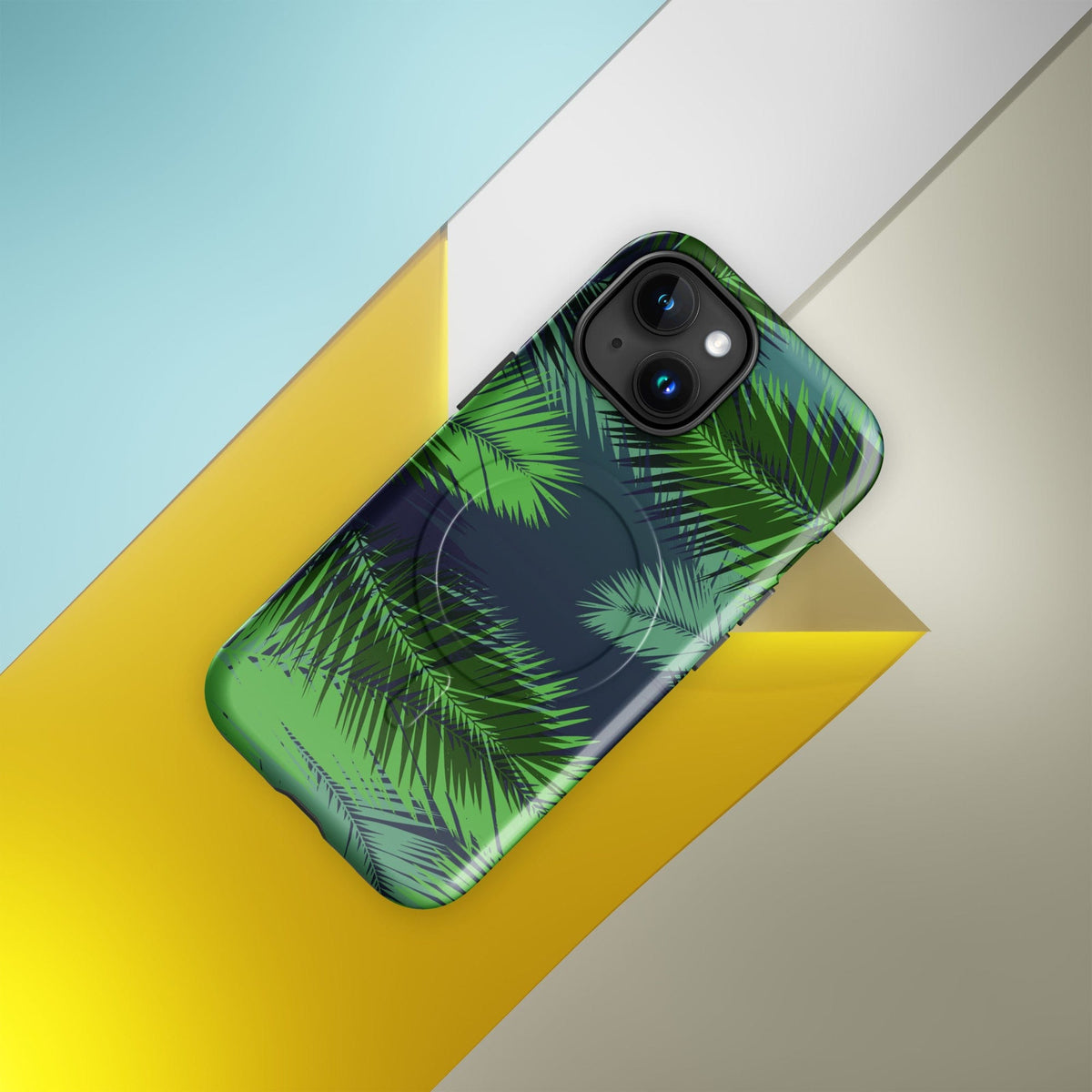Tropical phone case with green palm leaves pattern and MagSafe ring near camera