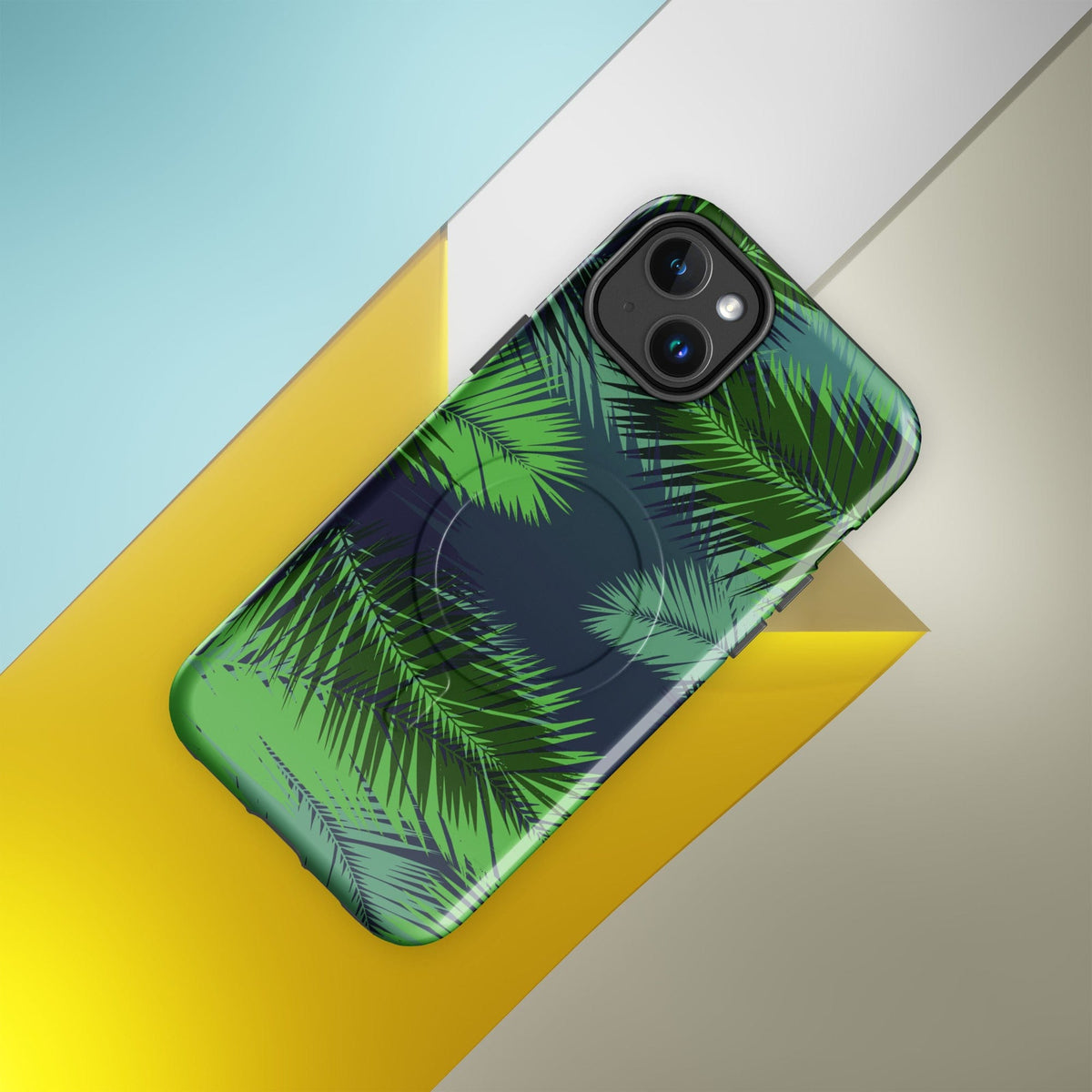Tropical MagSafe phone case with green palm leaves print and camera lens cutouts