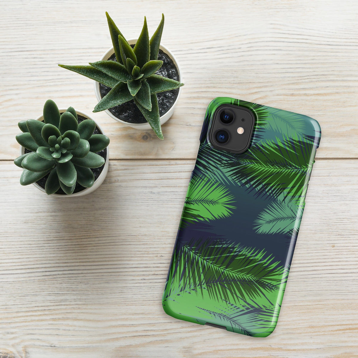 Palm leaf tropical iPhone snap case with green palm leaf print near succulents