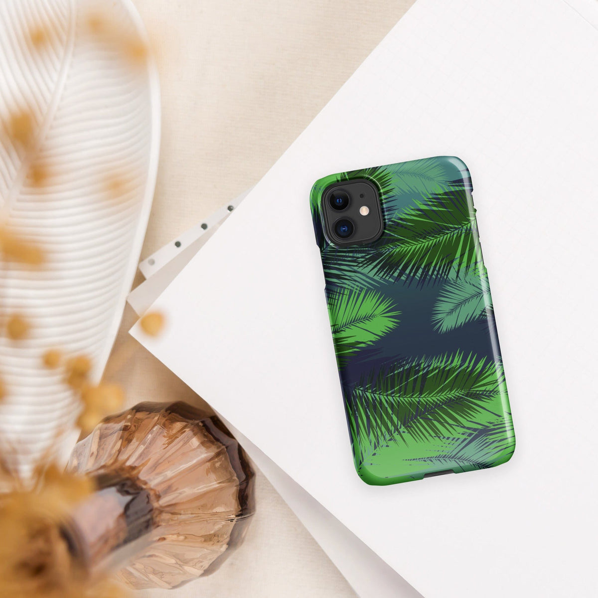 Palm leaf tropical iPhone snap case angled on light surface, green palm leaf print