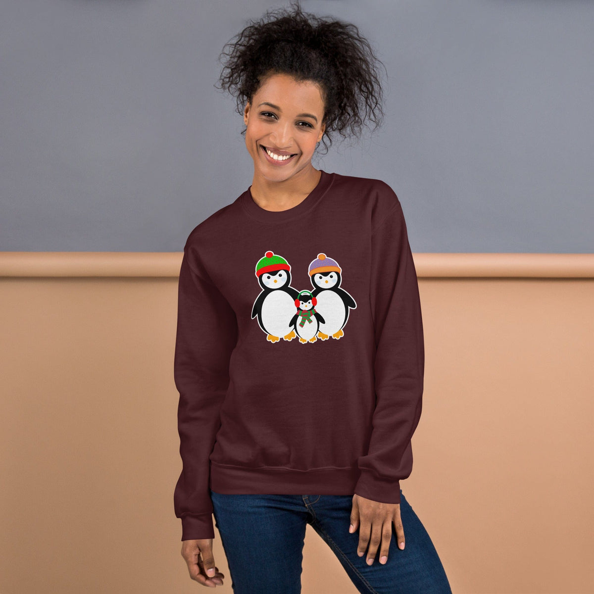 Maroon sweatshirt with a penguin family graphic at the center chest.