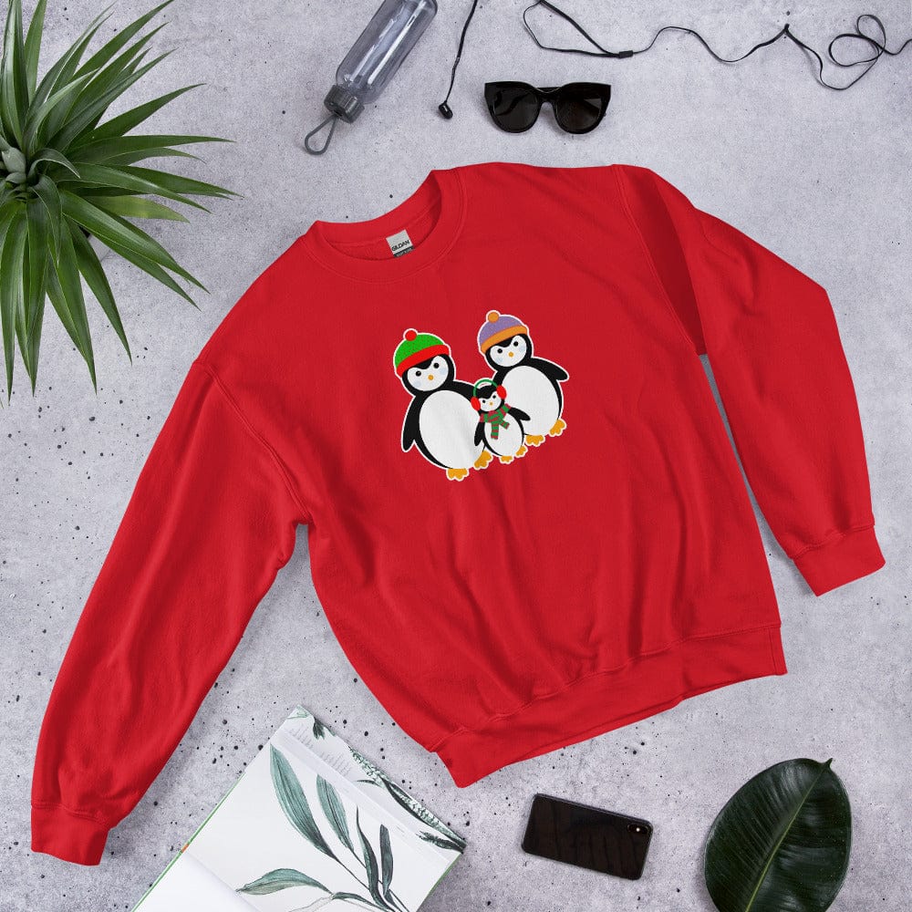 Red sweatshirt, laid flat, with a penguin family graphic on the chest.