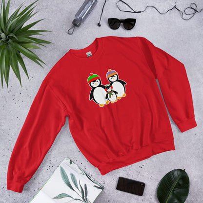 Red sweatshirt, laid flat, with a penguin family graphic on the chest.
