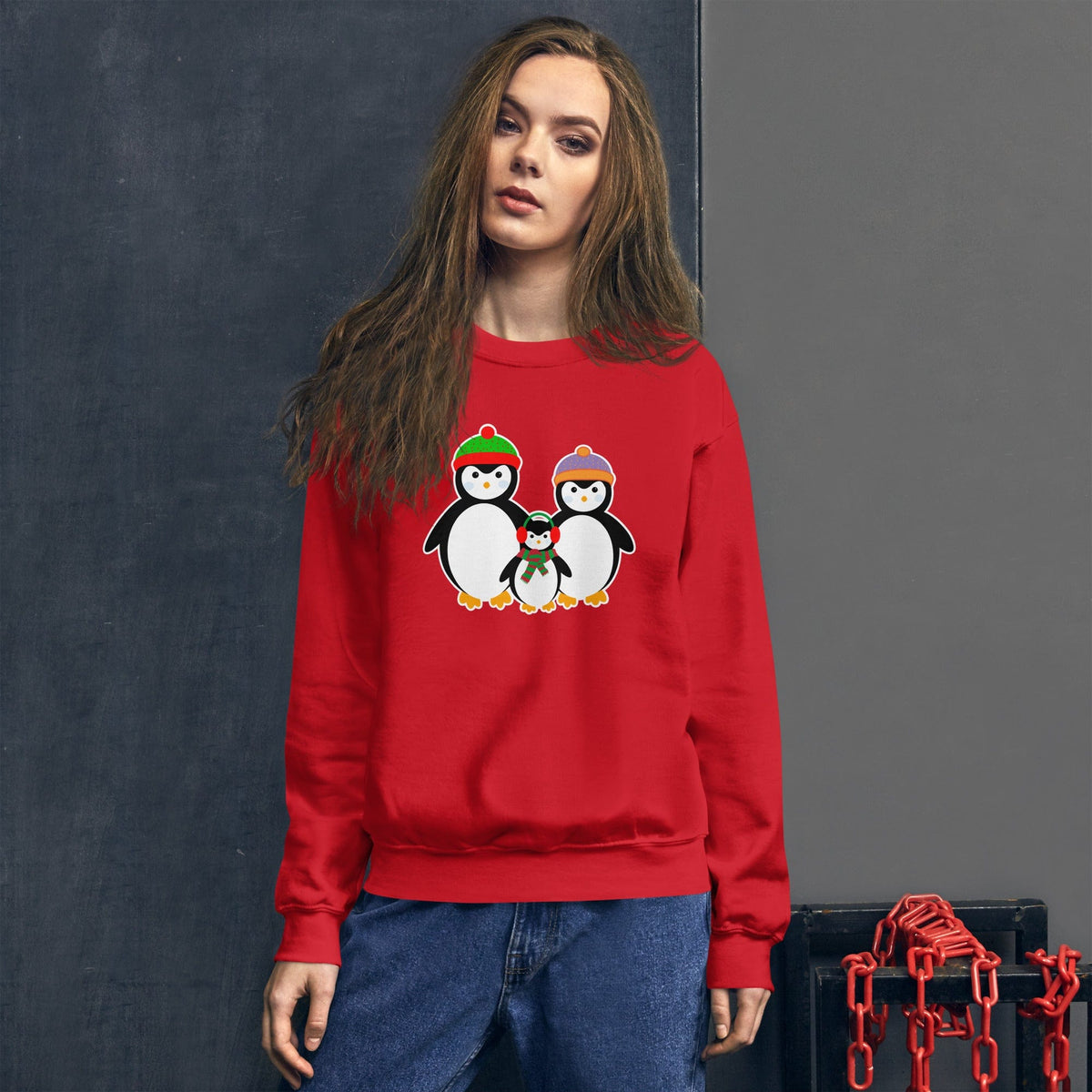 Red sweatshirt with penguin family graphic on the front, crewneck long sleeves