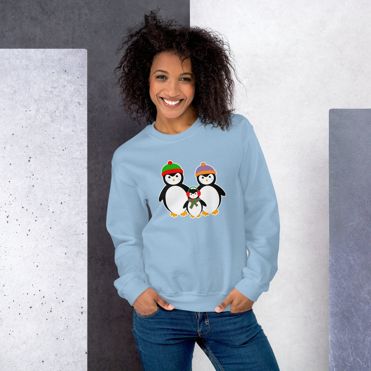 Light blue sweatshirt with penguin family graphic on front.
