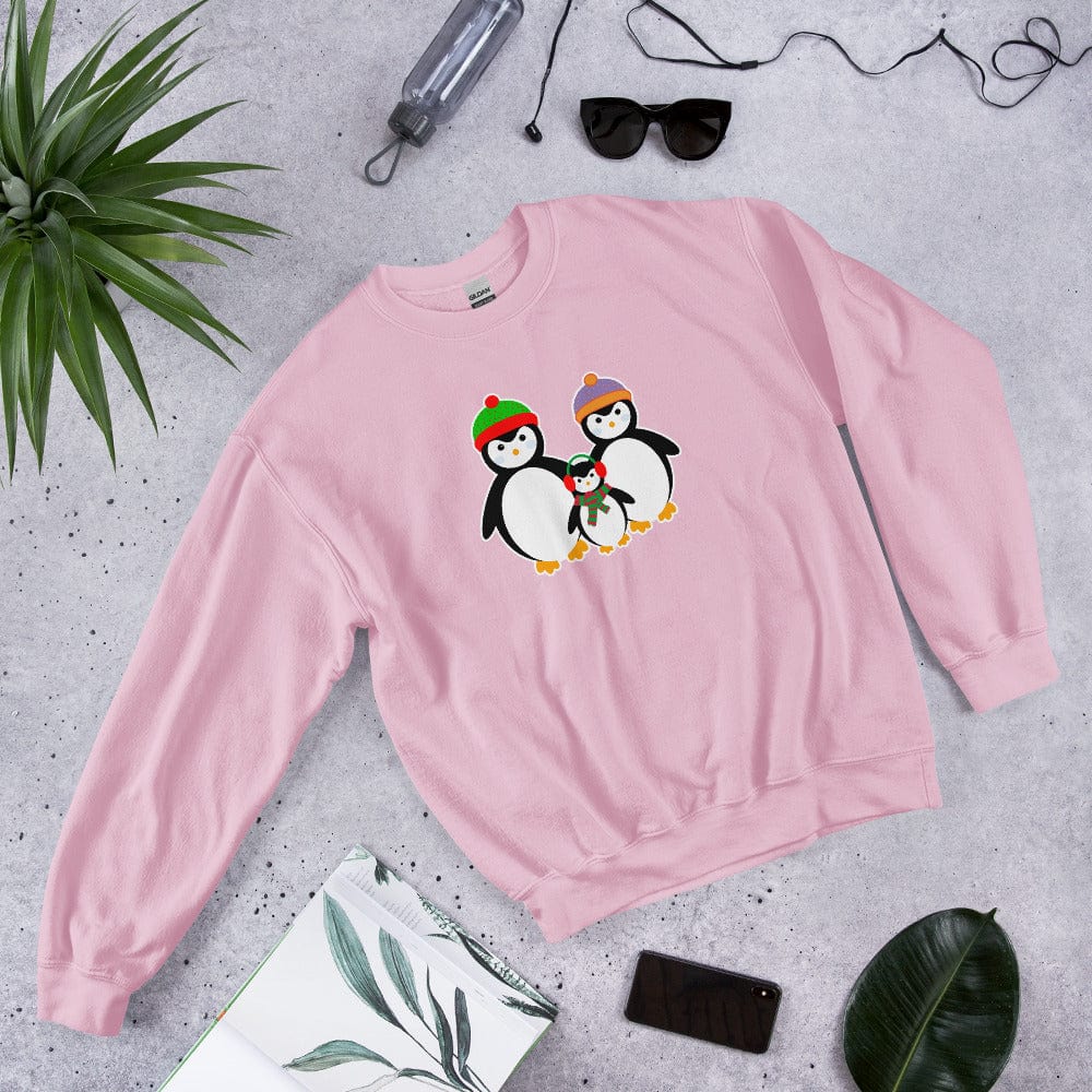 Pink sweatshirt laid flat with a penguin family graphic on the chest.