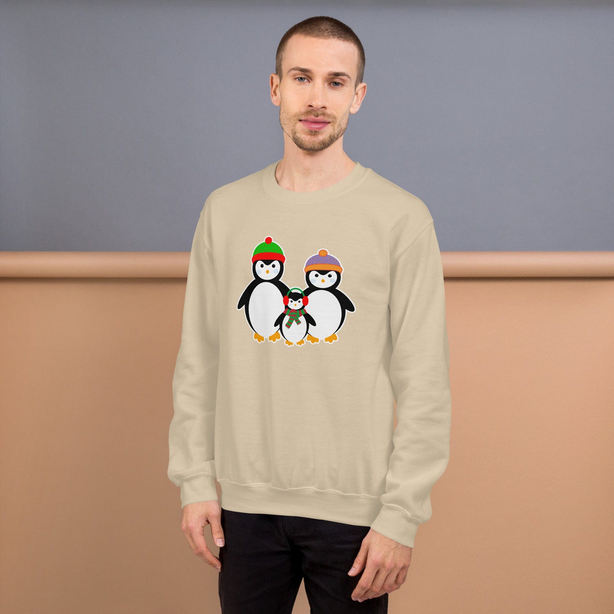 Sand-colored sweatshirt with penguin family graphic on front.