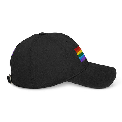 Black denim baseball cap with rainbow pride flag patch on side and metal buckle