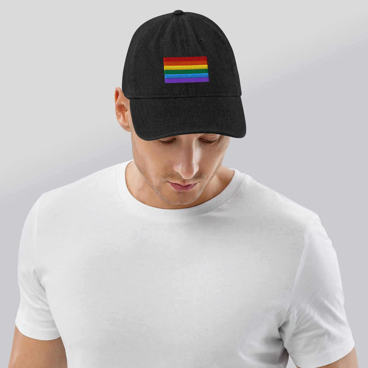 Black denim baseball cap with Pride rainbow flag embroidery, viewed from back