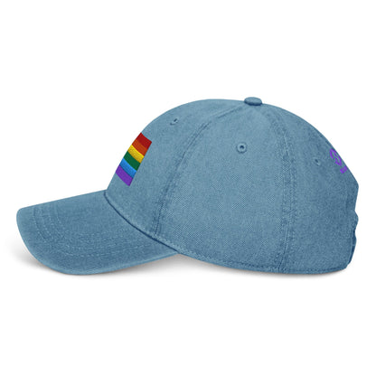 Light blue denim baseball cap with rainbow pride flag patch on side