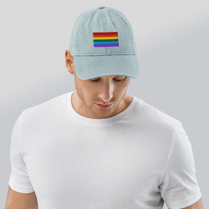 Light blue denim baseball cap with Pride rainbow flag embroidery, viewed from back