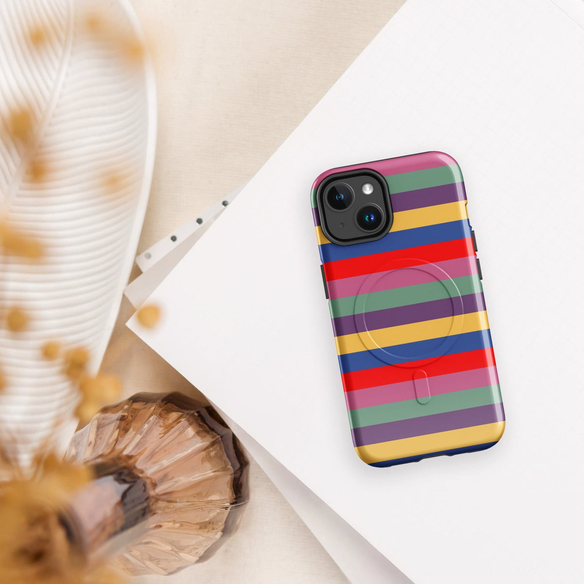 iPhone tough case, angled view, retro multicolor horizontal stripes and camera cutout