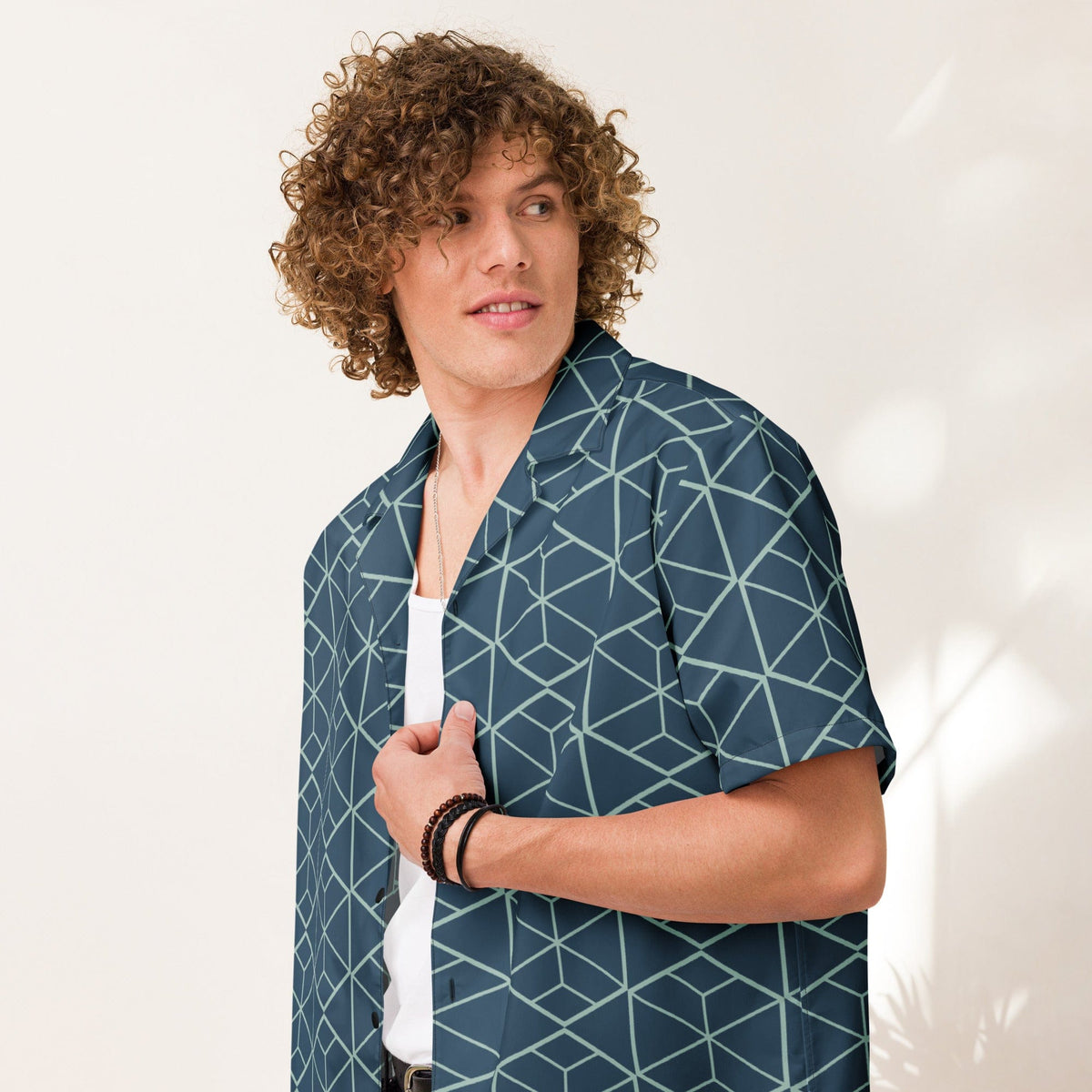 Dark teal geometric cube print shirt with short sleeves, button front, and camp collar