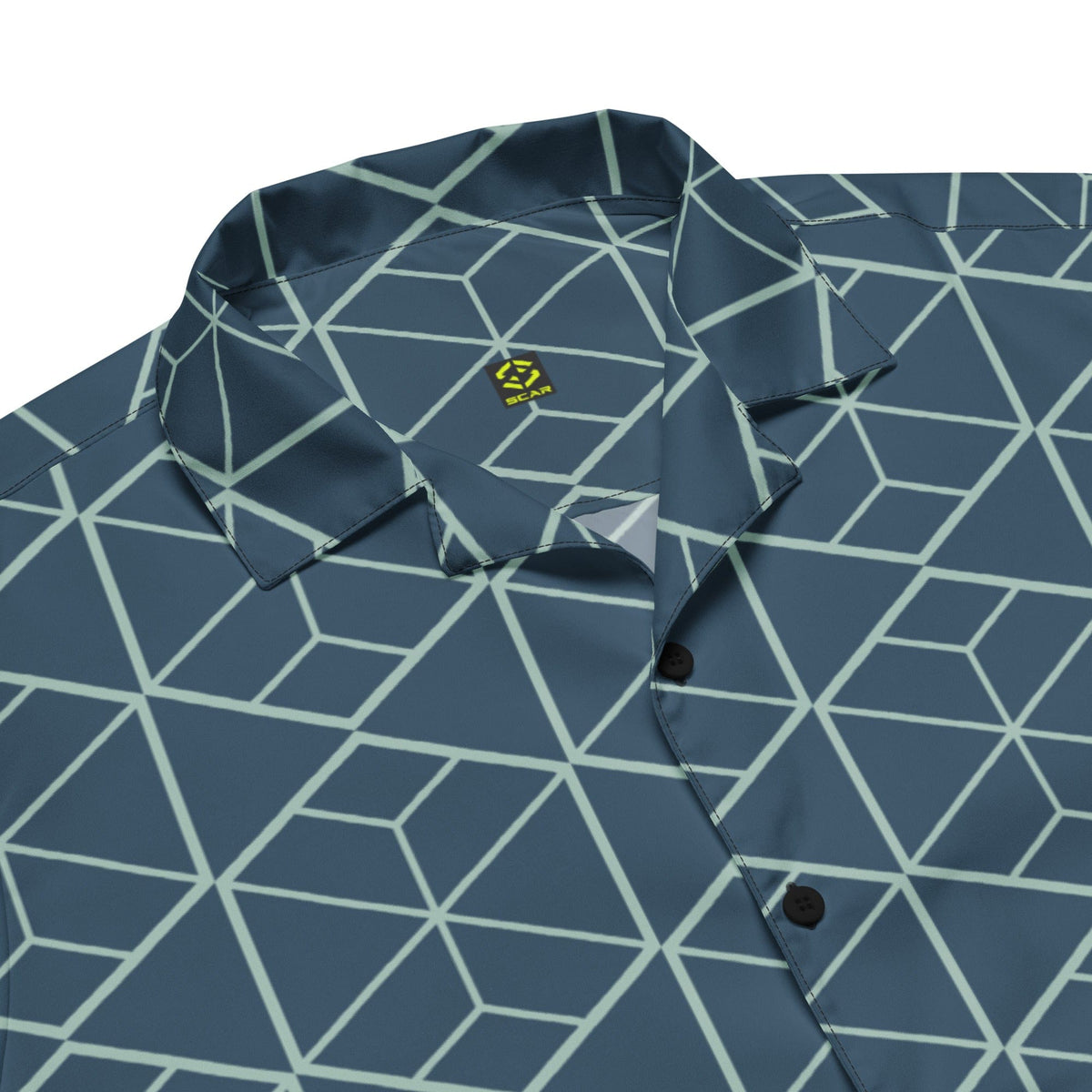 Close-up of dark teal geometric pattern short-sleeve shirt with button placket and camp collar