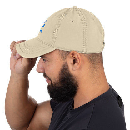 Distressed dad hat in khaki with curved brim and small distressed logo mark