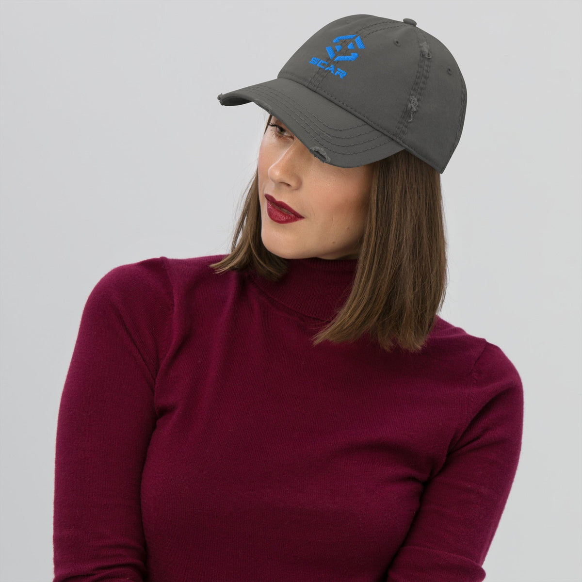 Distressed dad hat with embroidered SCAR logo, navy, side profile on model