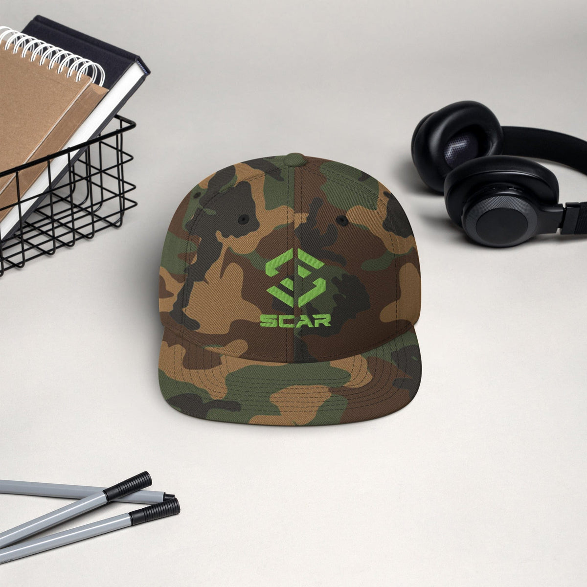 Snapback hat with embroidered SCAR logo, camouflage fabric crown and black top button.
