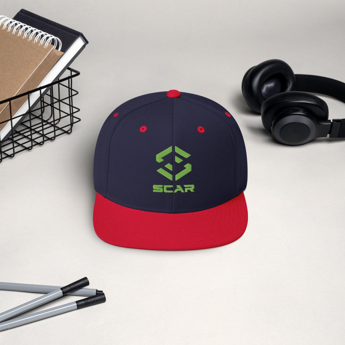 Logo snapback hat in navy and red brim with embroidered SCAR graphic on the front