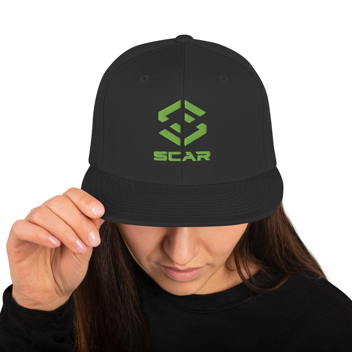 Black snapback hat with green SCAR logo embroidery on the front panel.