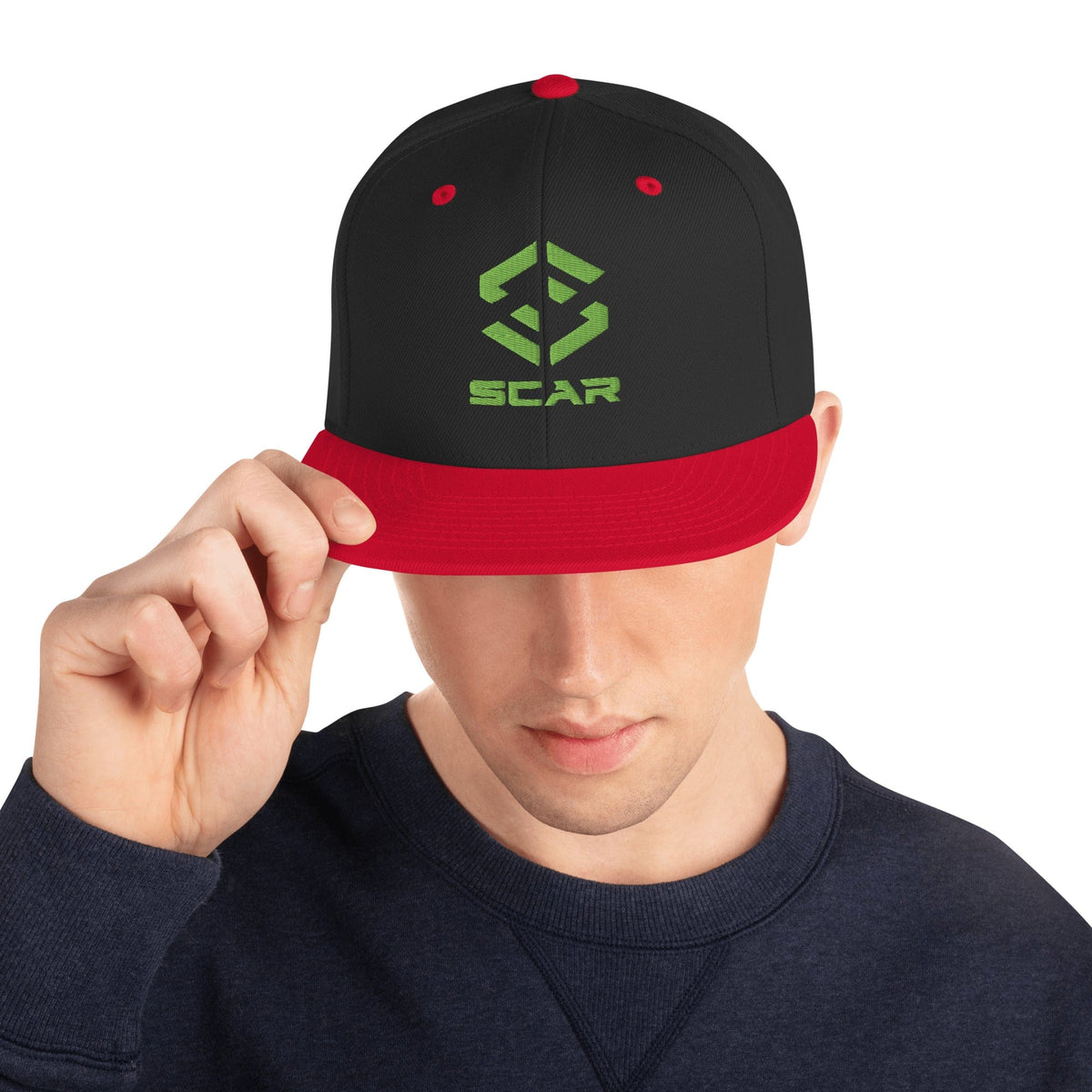 Black snapback hat with red brim, green SCAR logo, and red accent eyelets.