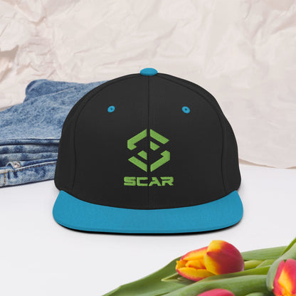 Snapback hat with embroidered SCAR logo, black crown and teal brim.