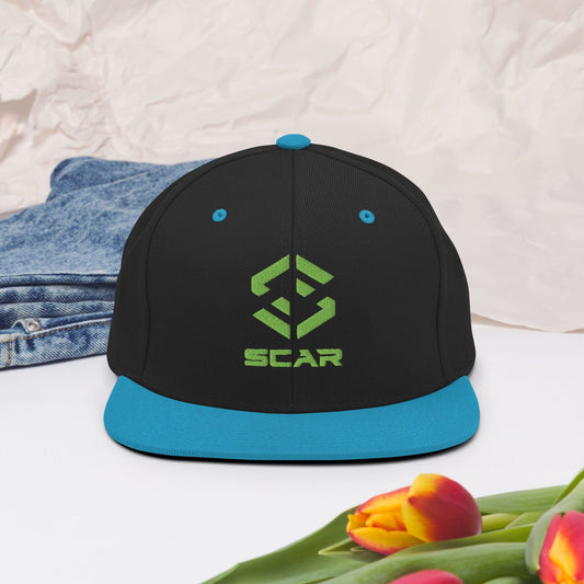 Snapback hat with embroidered SCAR logo, black crown and teal brim.