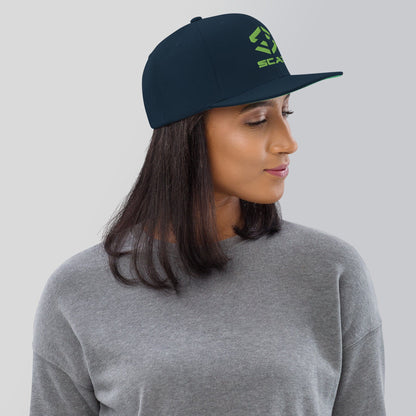 Dark navy snapback hat with green SCAR logo embroidery and flat brim.