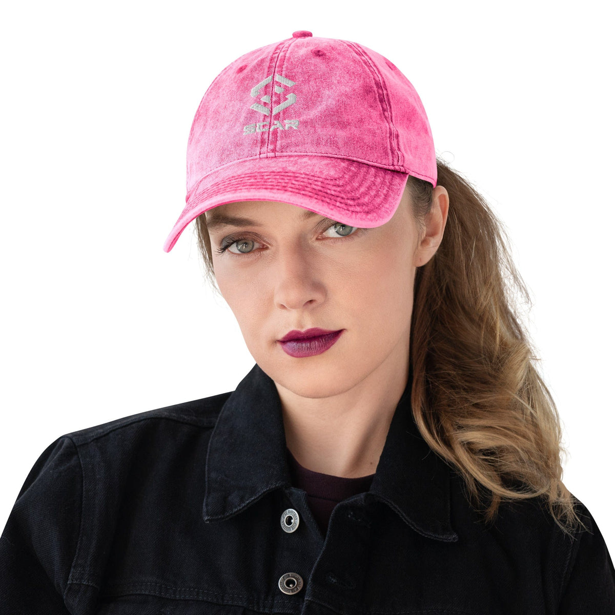Pink vintage cotton twill cap worn by a person, with embroidered logo and curved brim