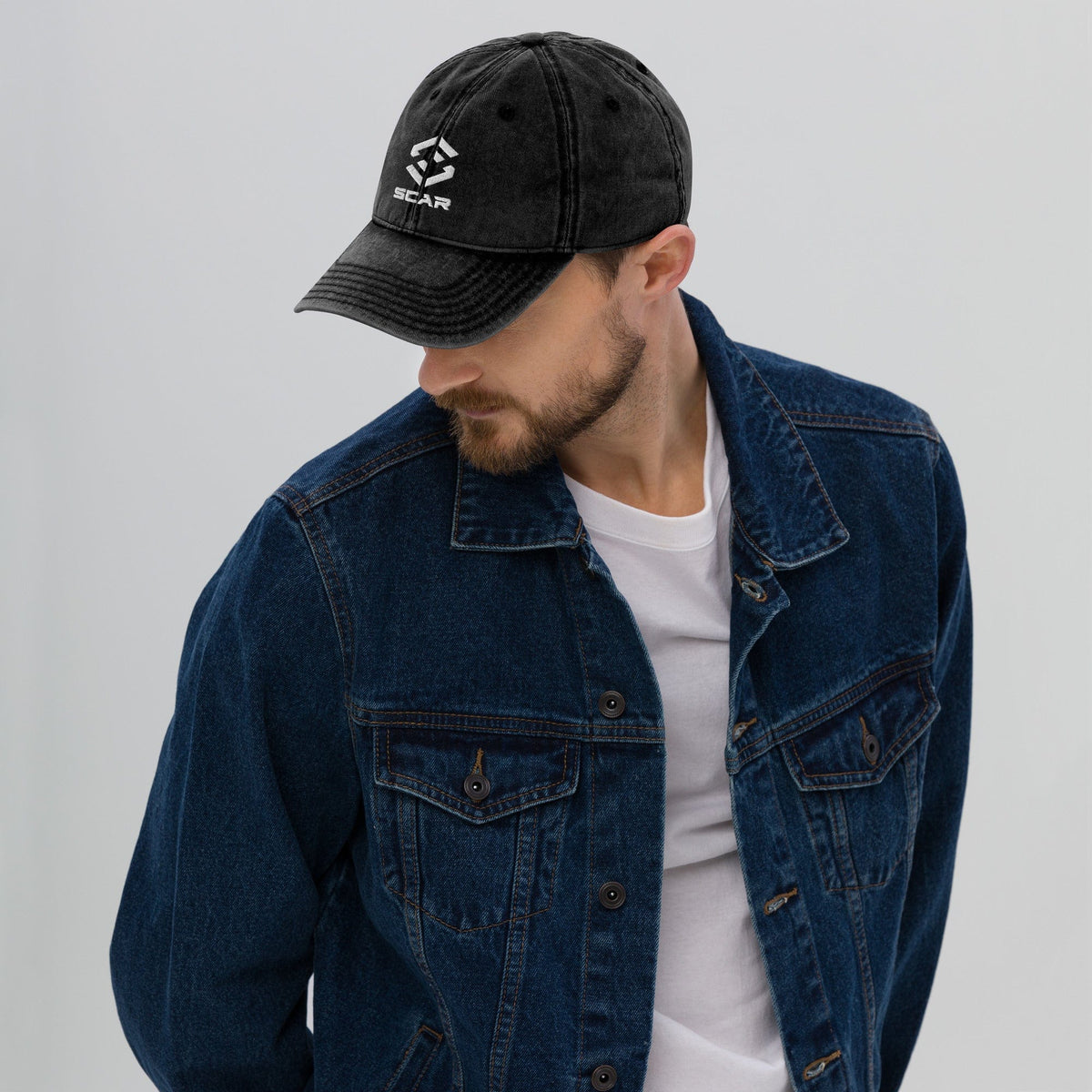 Black vintage cotton twill cap with embroidered STAR logo, worn with denim jacket