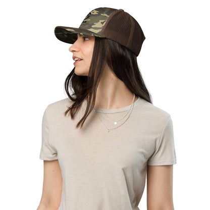 Camouflage trucker hat with black mesh back viewed from the side