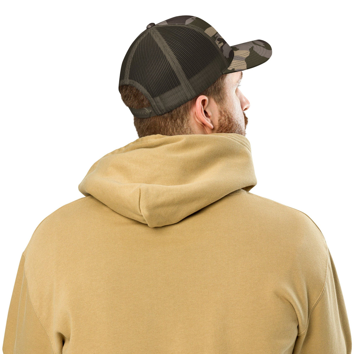Camouflage trucker hat with black mesh back viewed from the side