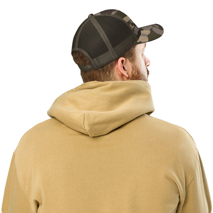 Camouflage trucker hat with black mesh back viewed from the side