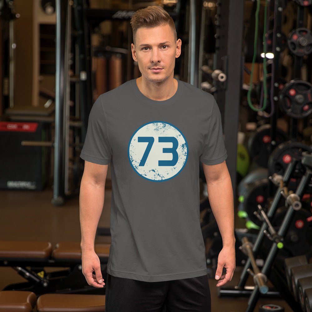 Dark gray T-shirt with circular “73” graphic on the chest.