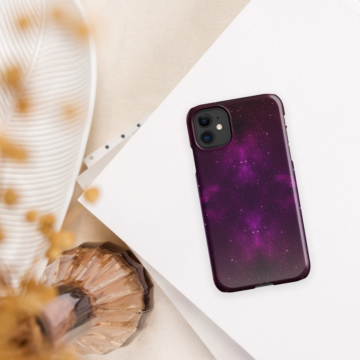 Purple galaxy iPhone snap case with dual camera cutout and maroon trim, tilted