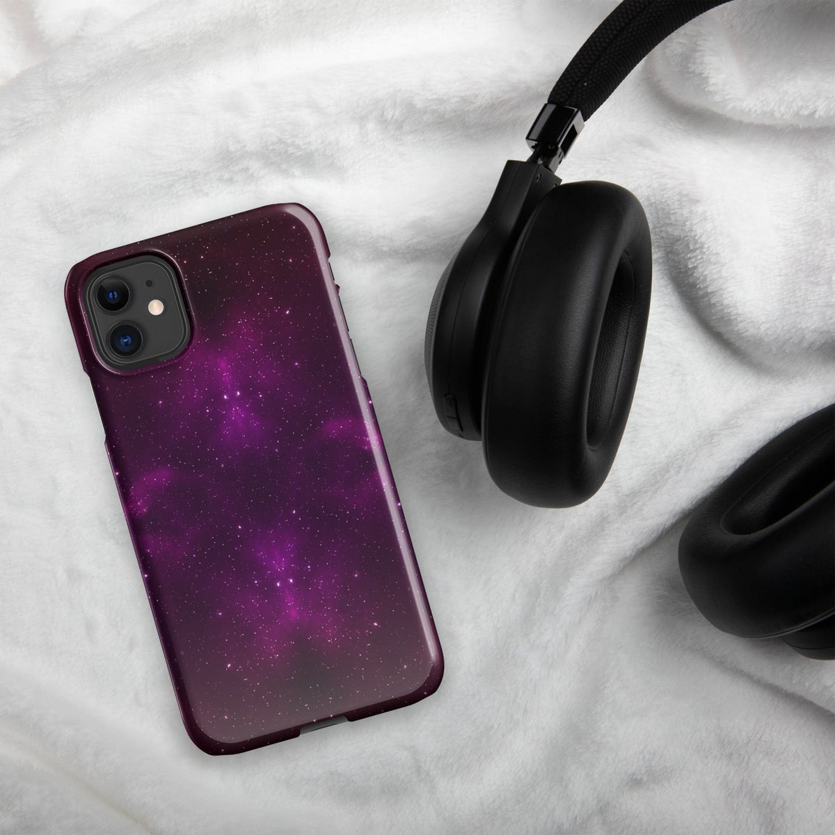 Purple galaxy iPhone snap case with dual camera cutouts and maroon border on cloth