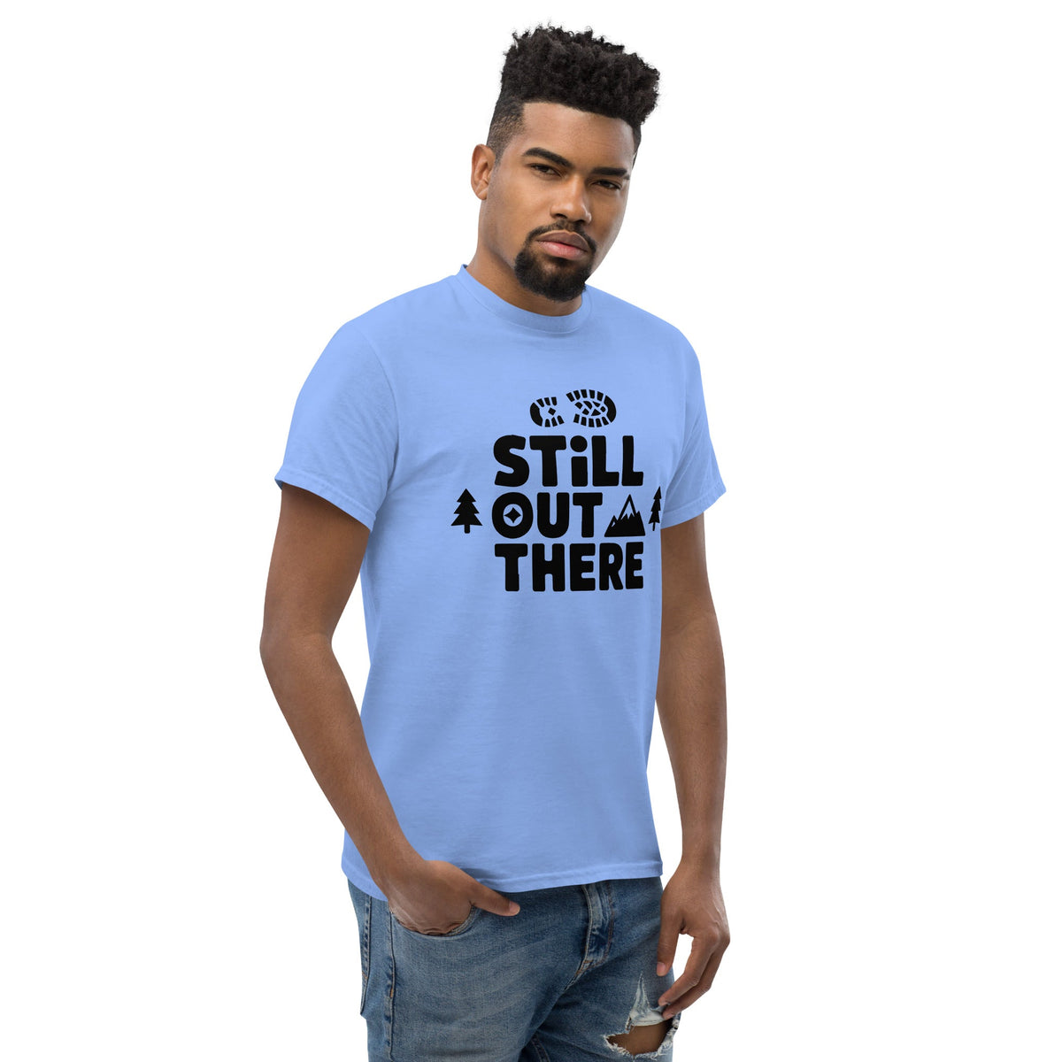 Light blue hiking T-shirt with black “Still Out There” logo graphic and paw-tree icon