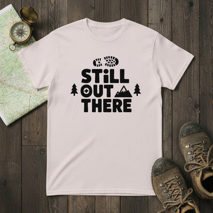 Light pink hiking T-shirt with black 'Still Out There' logo and tree graphic