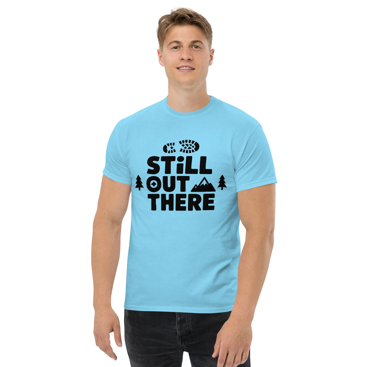 Sky blue hiking T-shirt with black “Still Out There” logo graphic and paw-tree icon