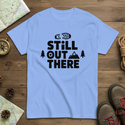 Light blue hiking T-shirt with black 'Still Out There' logo and tree graphic