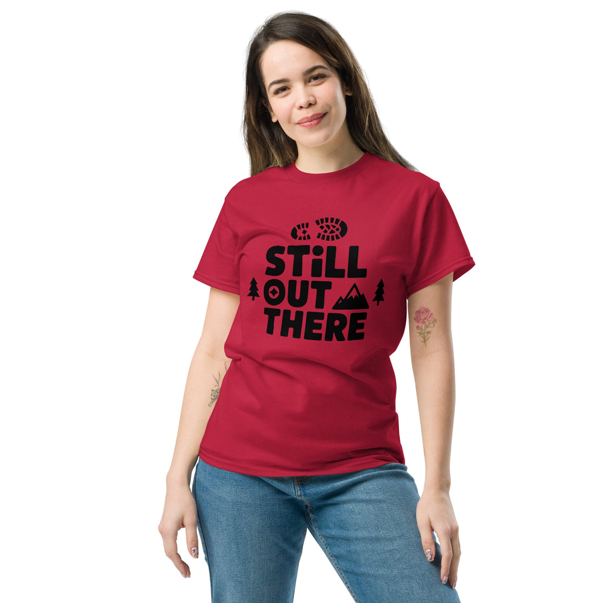 Red hiking T-shirt with black “Still Out There” logo graphic and paw-tree icon