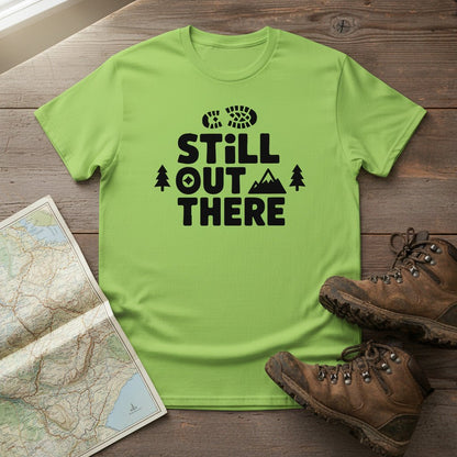 Lime green hiking T-shirt with black 'Still Out There' logo and tree graphic