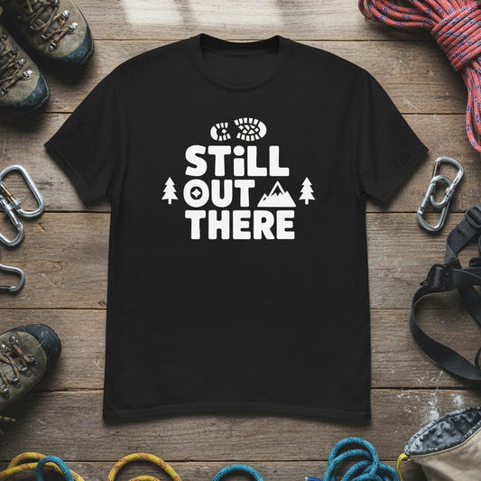 Black hiking T-shirt with white 'Still Out There' logo graphic on chest