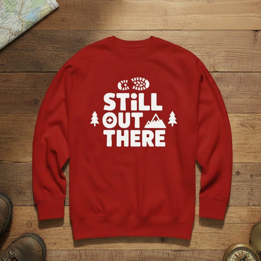 Red hiking sweatshirt with crew neck and white “Still Out There” logo