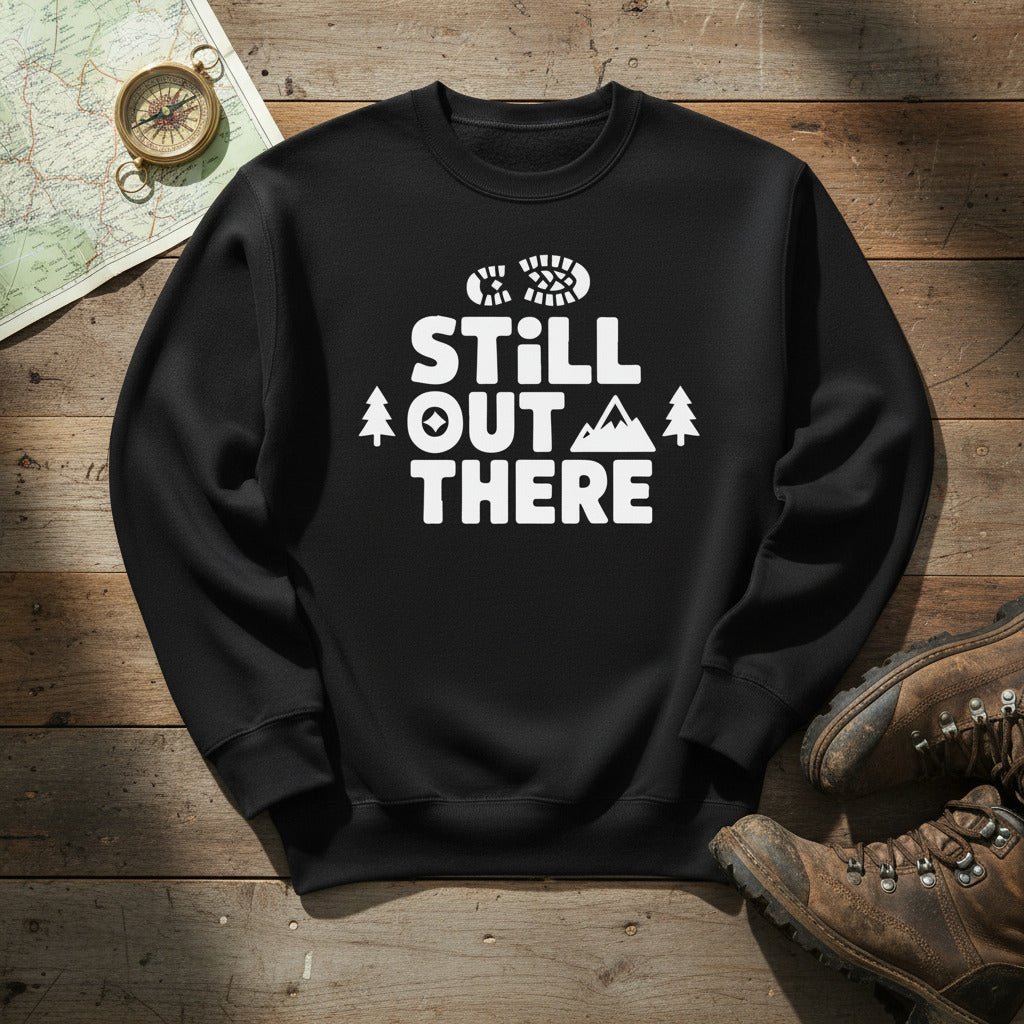 Black hiking sweatshirt with crew neck and white “Still Out There” logo