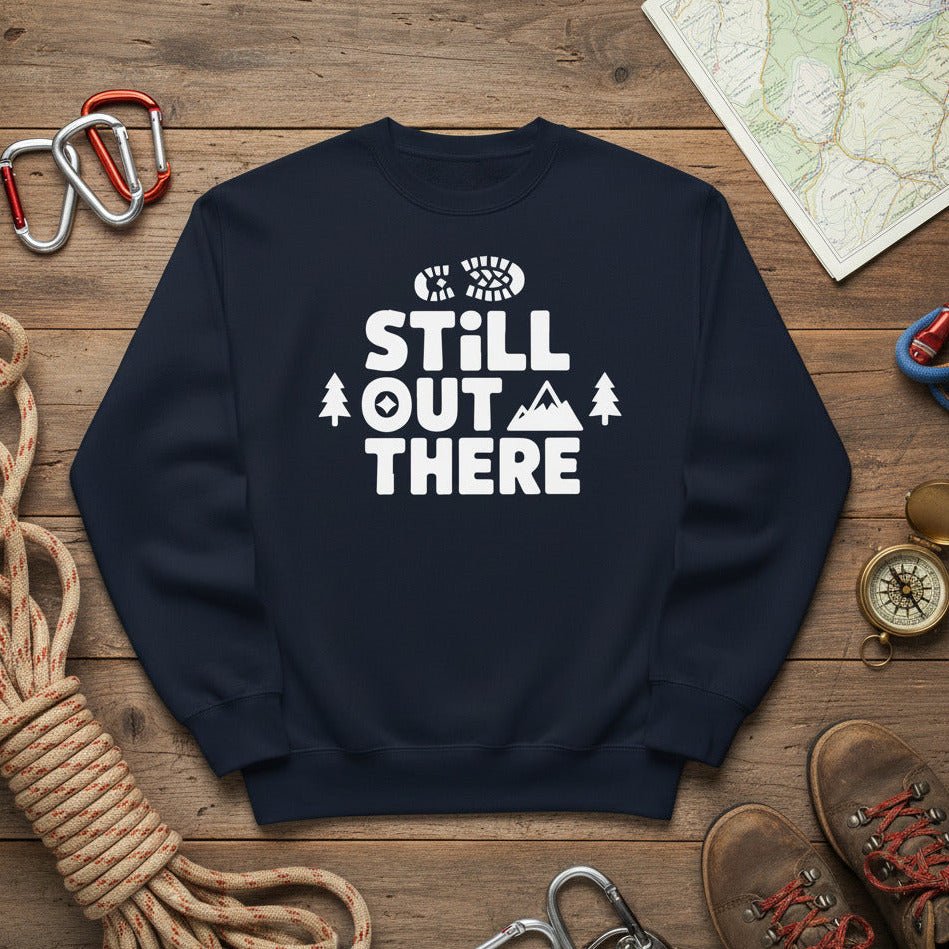 Navy hiking sweatshirt with crew neck and white “Still Out There” logo