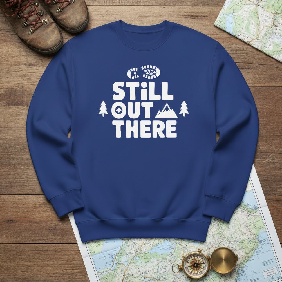 Blue hiking sweatshirt with crew neck and white “Still Out There” logo