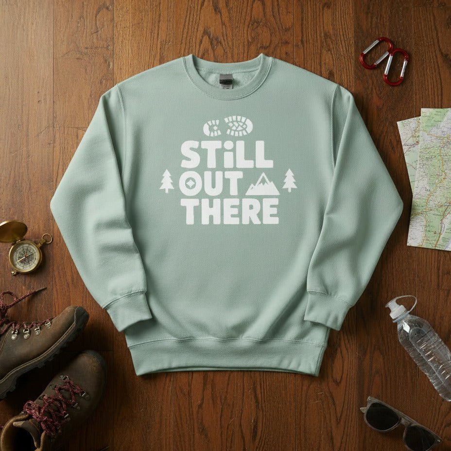 Light mint hiking sweatshirt with crew neck and white “Still Out There” logo