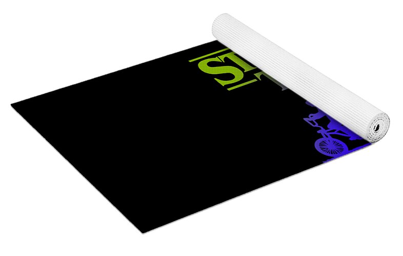 Kids yoga mat rolled with black surface and Stranger Things logo in green and purple